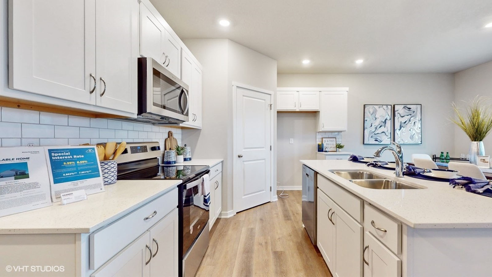Kitchen with white cabinets and overhead lighting