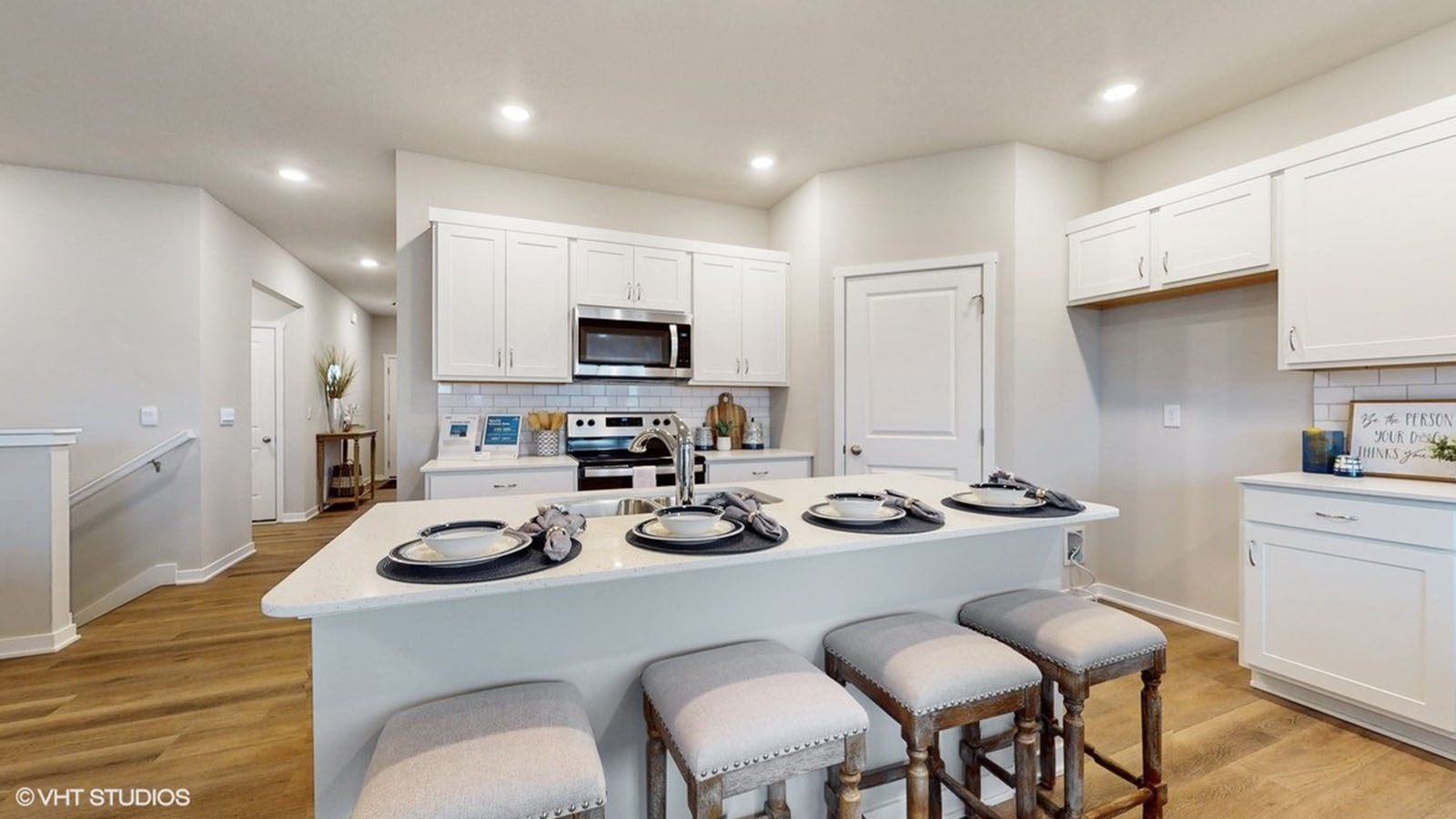 Kitchen with island and four barstools