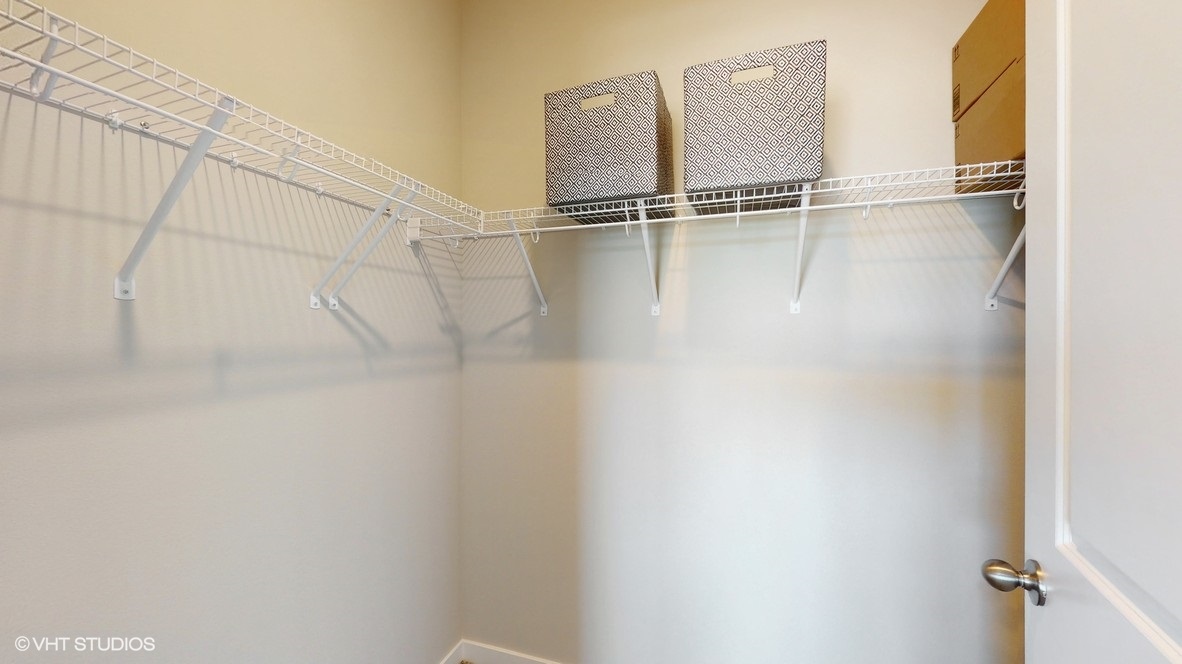 Primary bedroom walk-in closet