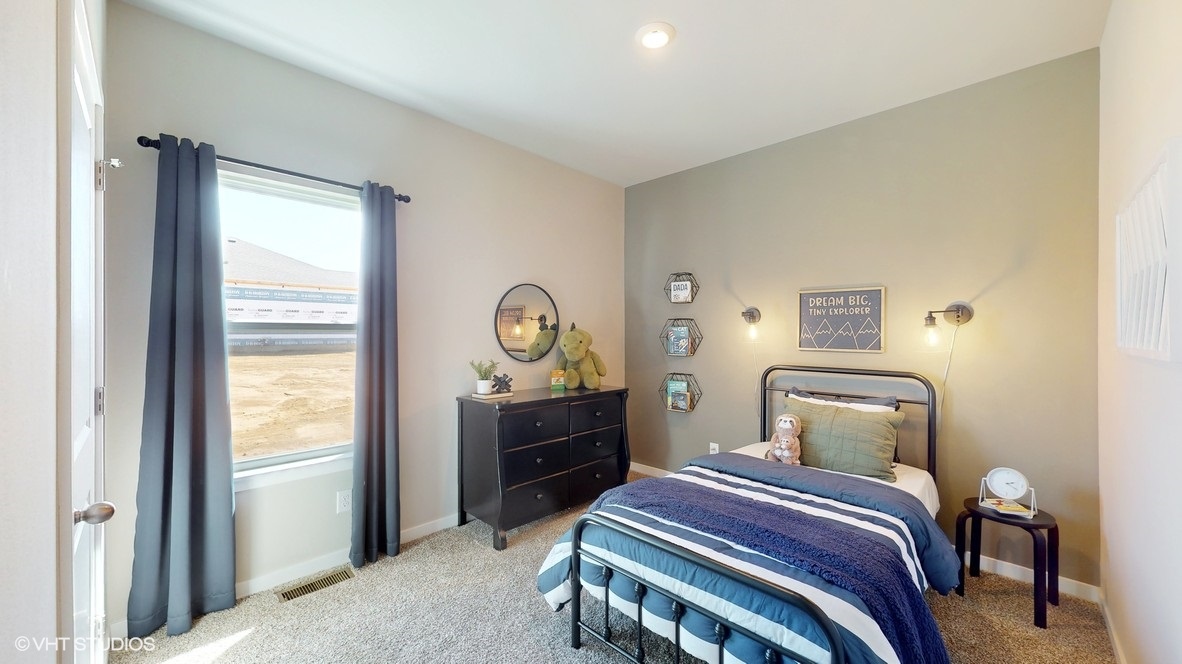 Second bedroom with dresser and window
