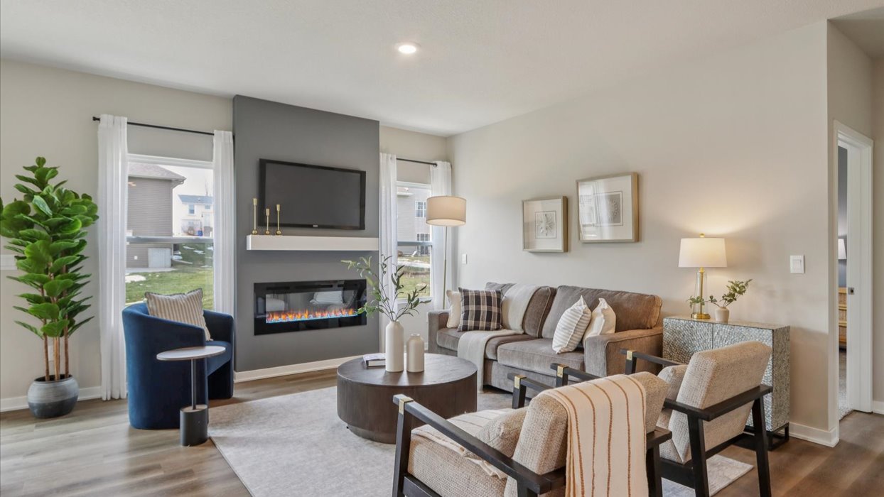 bright and spacious jack living room with accent wall and electric fireplace