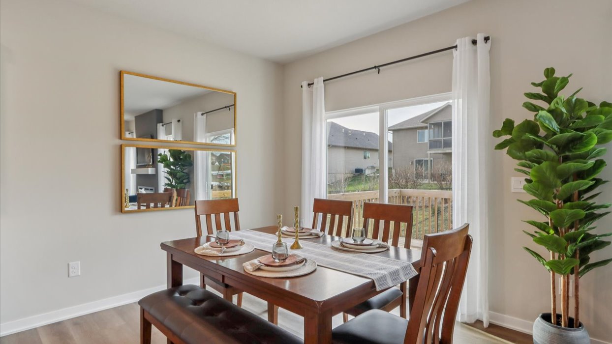 dining area with wood dining table next to sliding glass doors
