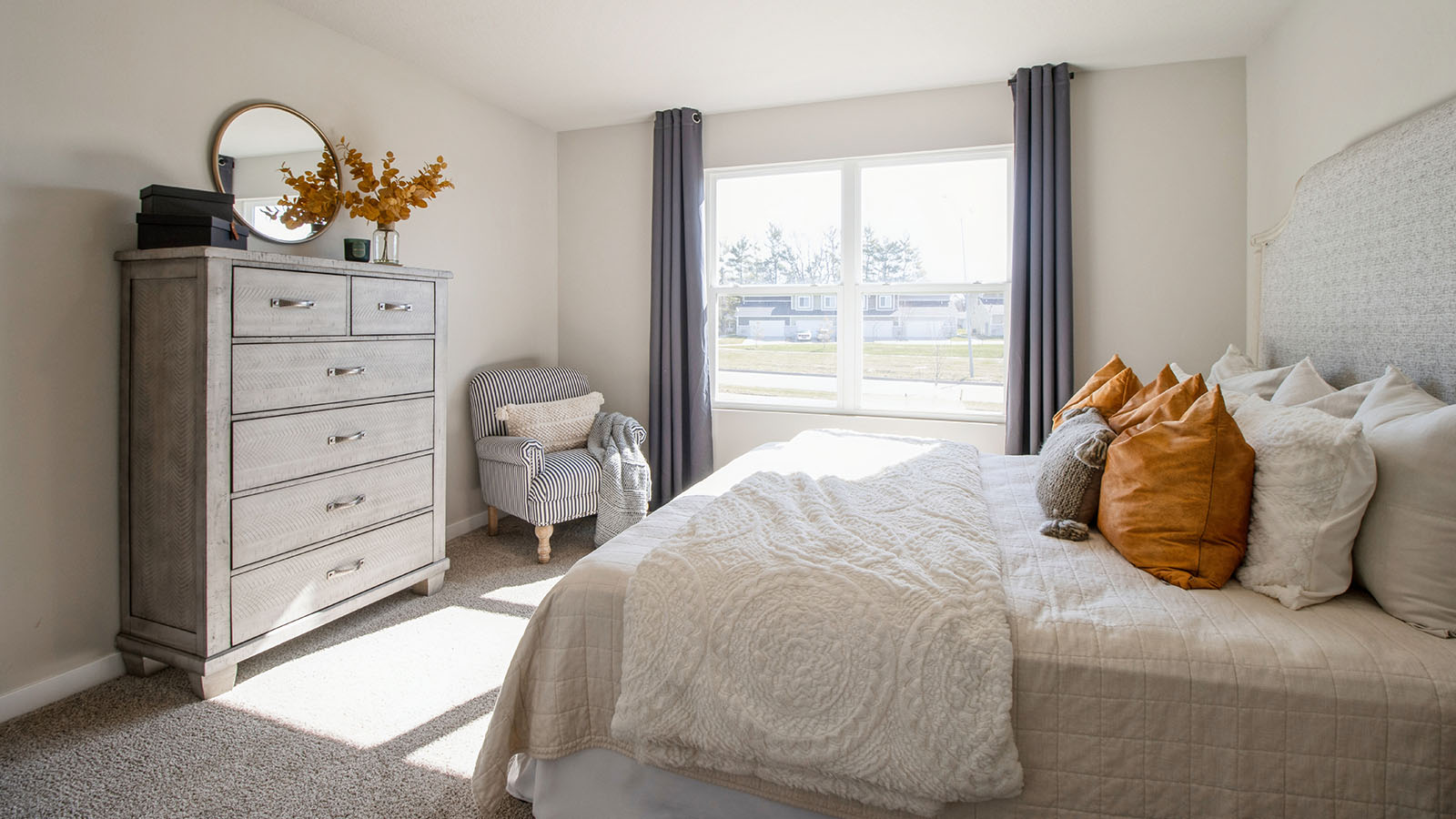 Primary bedroom wit carpeted floors.