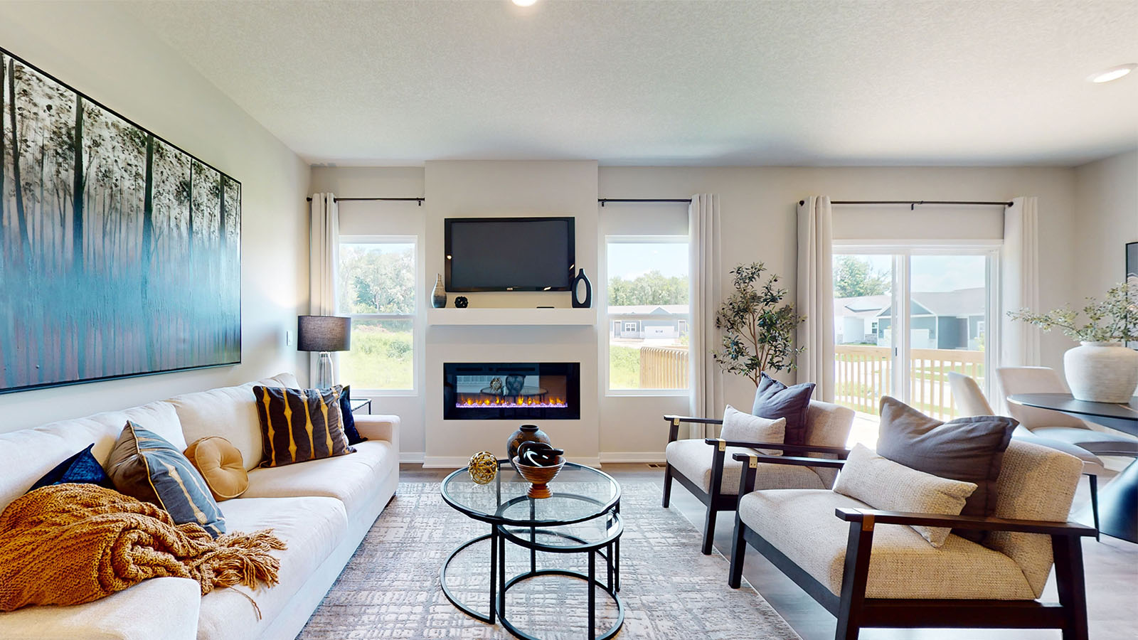 living room with white couch and two chairs