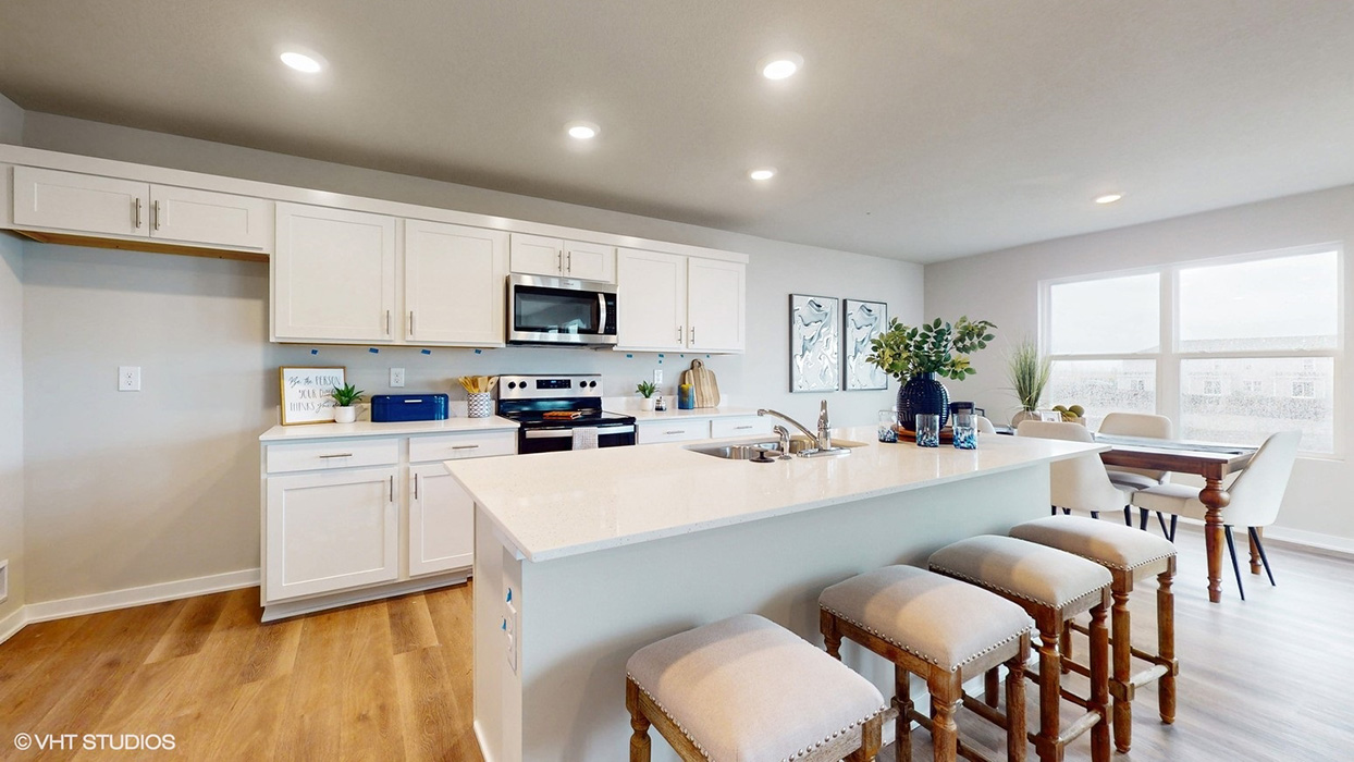 Interior kitchen with center island and white cabinets