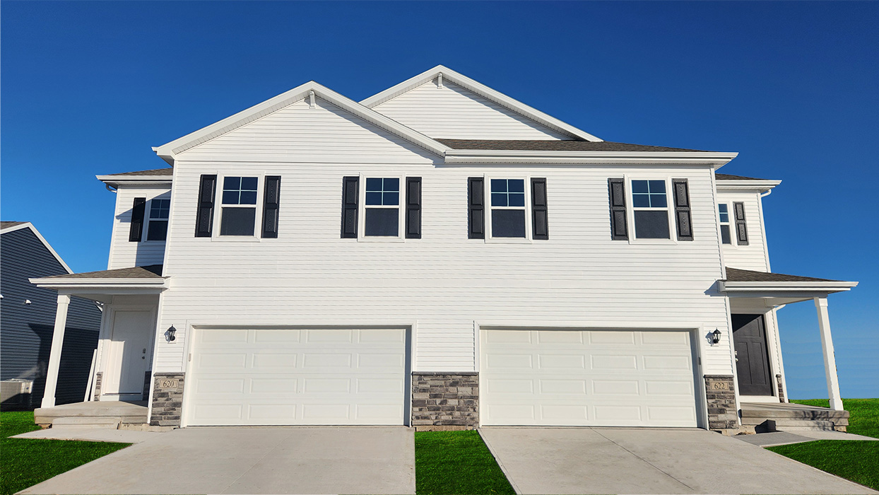 Exterior white two-story home with stone detailing