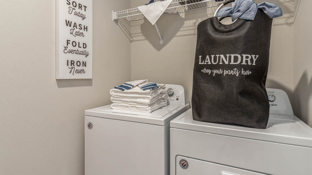 Laundry room with a built in storage shelf.