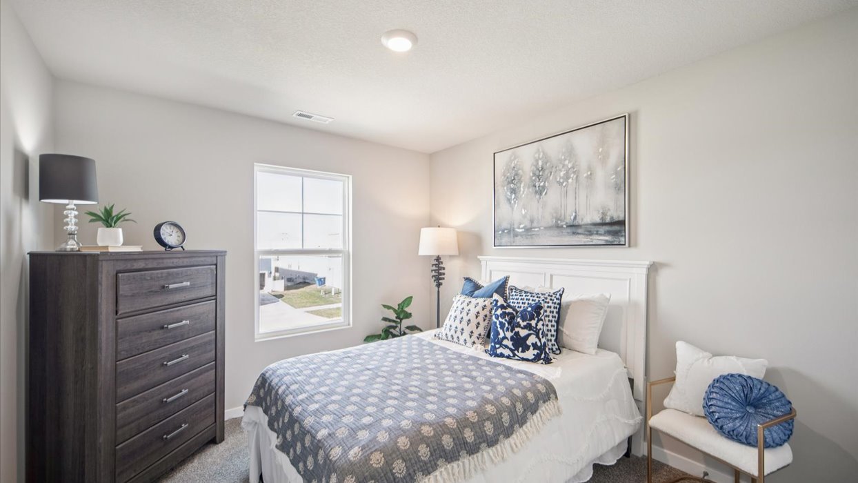 Comfortable secondary bedroom with natural light, modern finishes, and versatile living space.