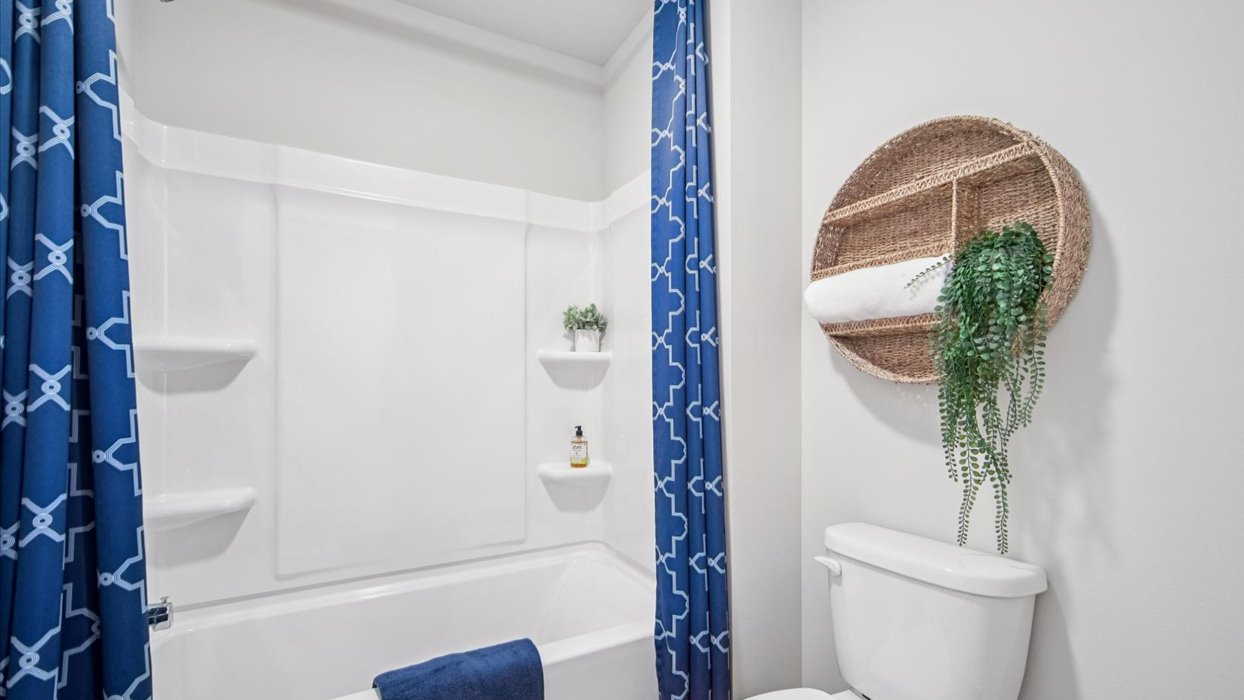 Bathroom with tub and shower combo, quartz countertops, and white vanity