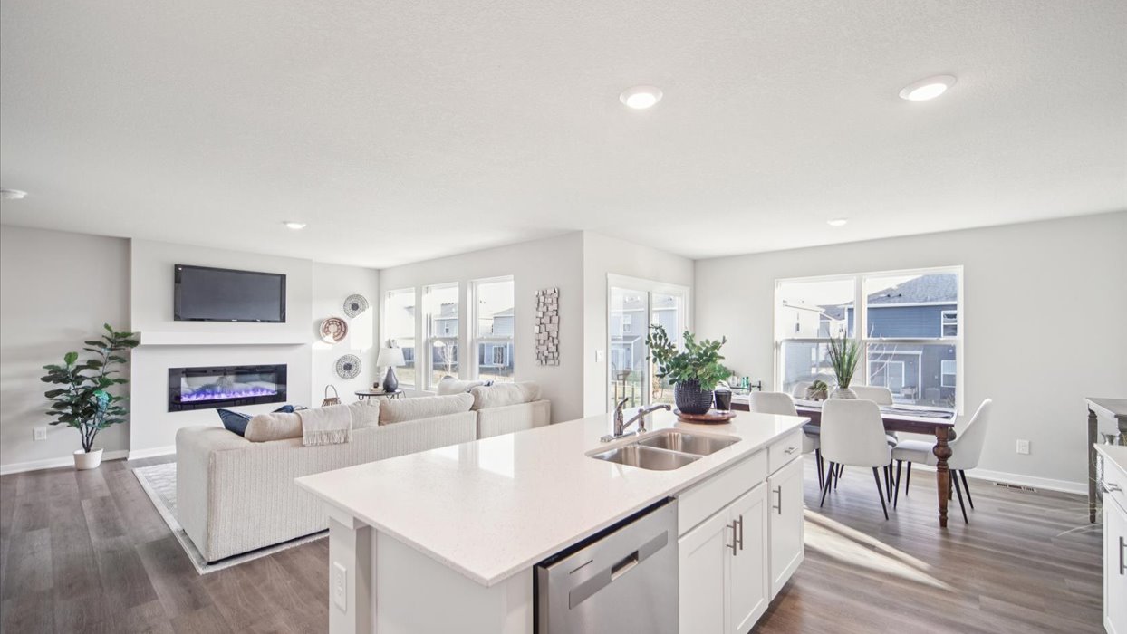 Kitchen with stainless steel appliances, quartz countertops, and white cabinetry
