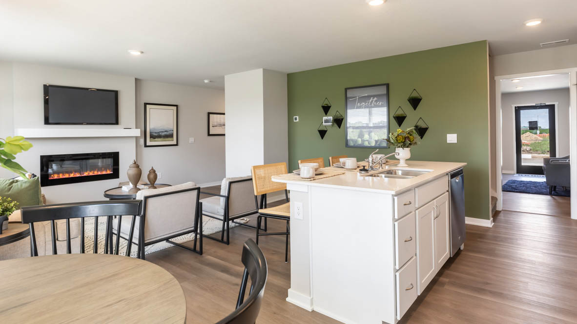 Kitchen with stainless steel appliances, quartz countertops, and white cabinetry