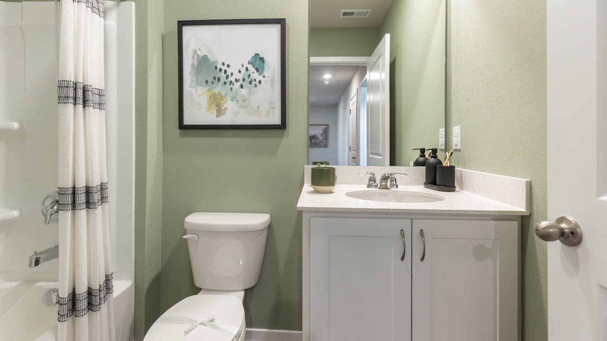 Bathroom with tub and shower combo, quartz countertops, and white vanity