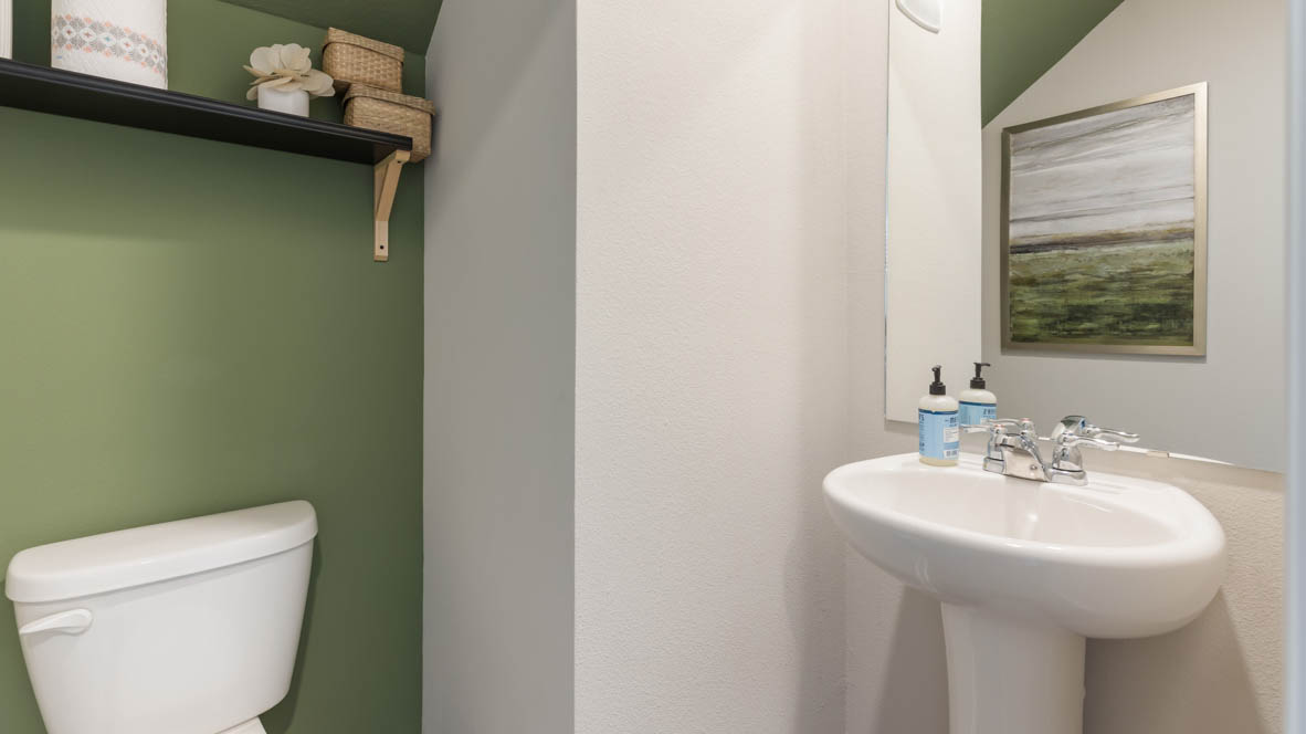 Convenient main-level powder room with updated fixtures and bright lighting.