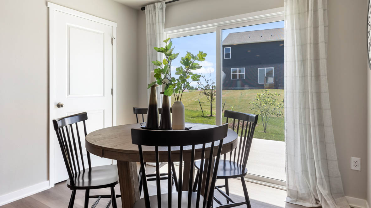 Open concept dining space with access to backyard