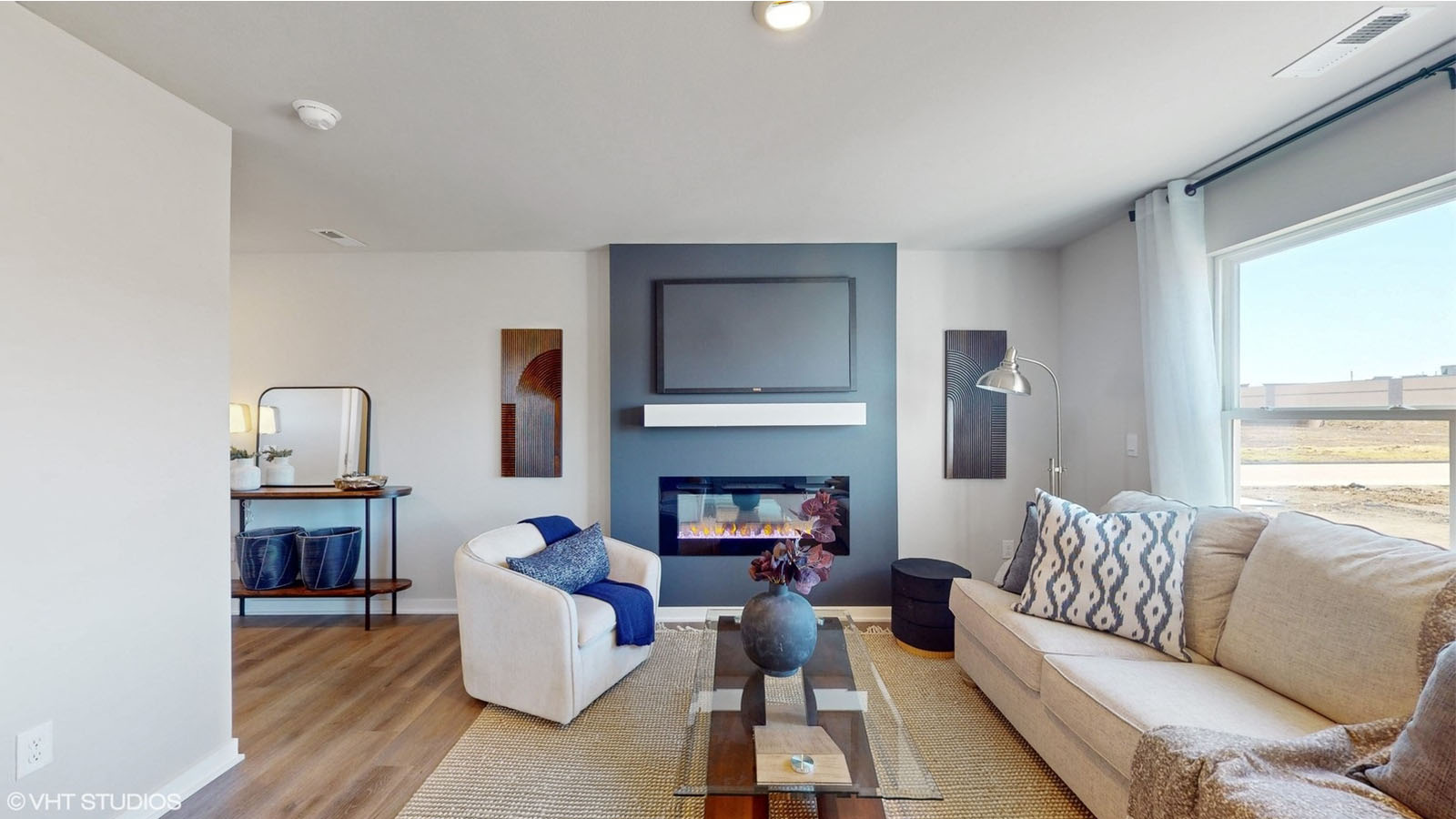 living room spotlighting fireplace and main entrance
