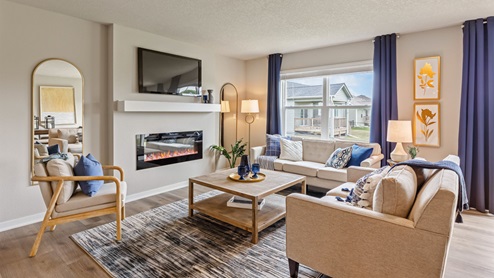 Roland Living room with a couch and two chairs circled around the electrical fireplace