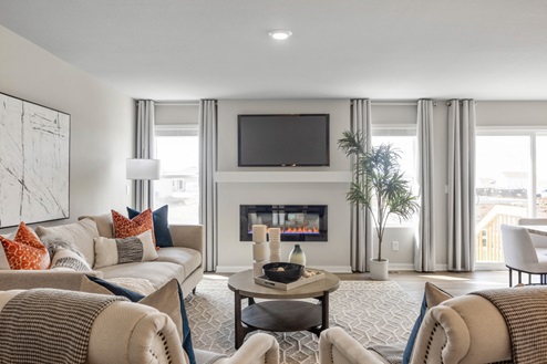overview of the living in the hamilton with two couches around a fireplace