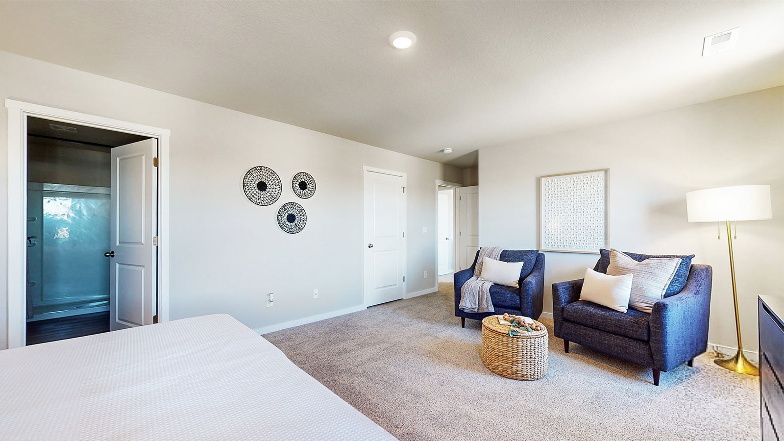 Spacious primary suite with natural light, attached bathroom, & walk in closet