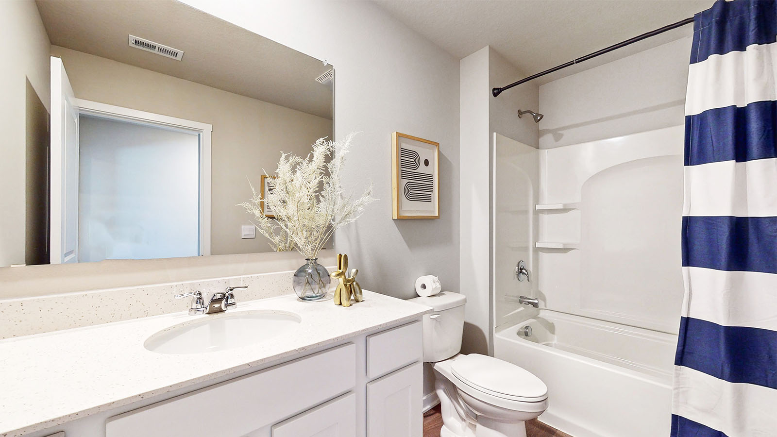 Bathroom with tub and shower combo, quartz countertops, and white vanity