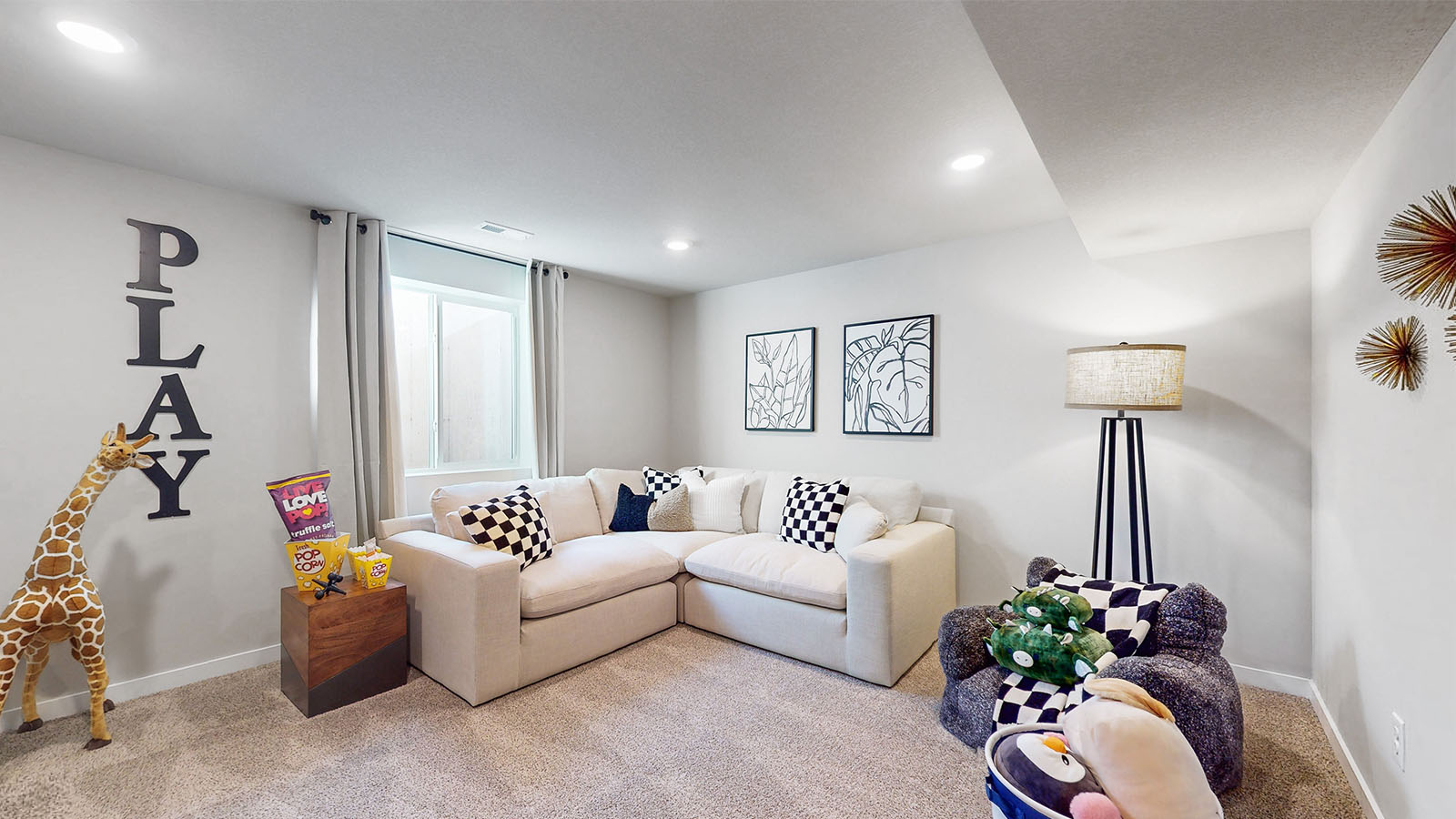 Finished basement living area with comfortable seating space and flexible room for entertaining or relaxing.