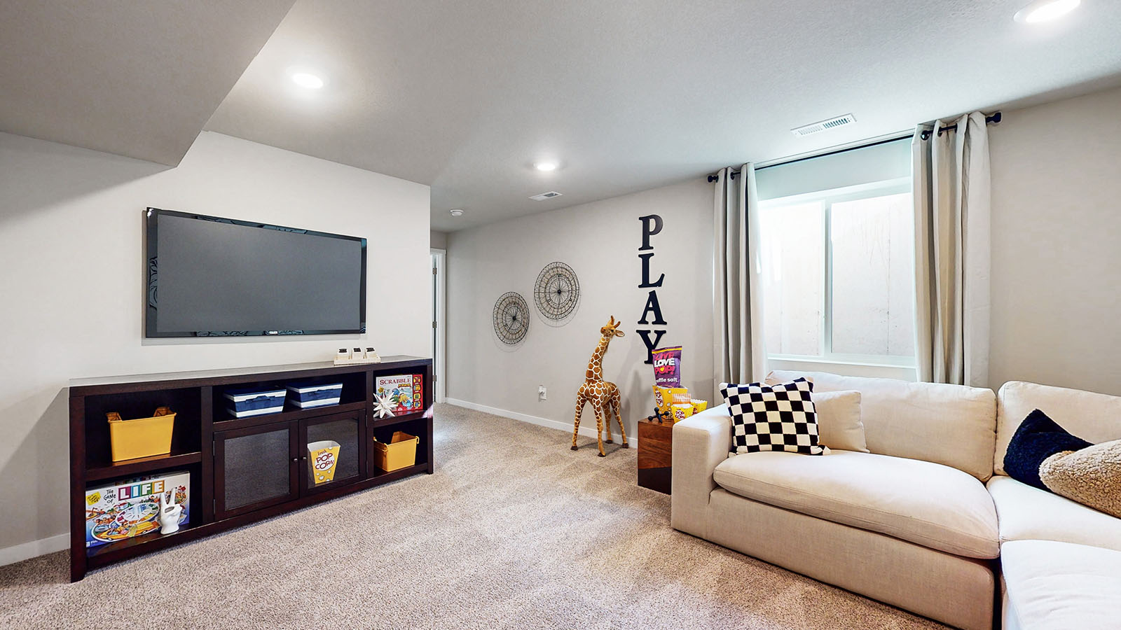 Finished basement living area with comfortable seating space and flexible room for entertaining or relaxing.
