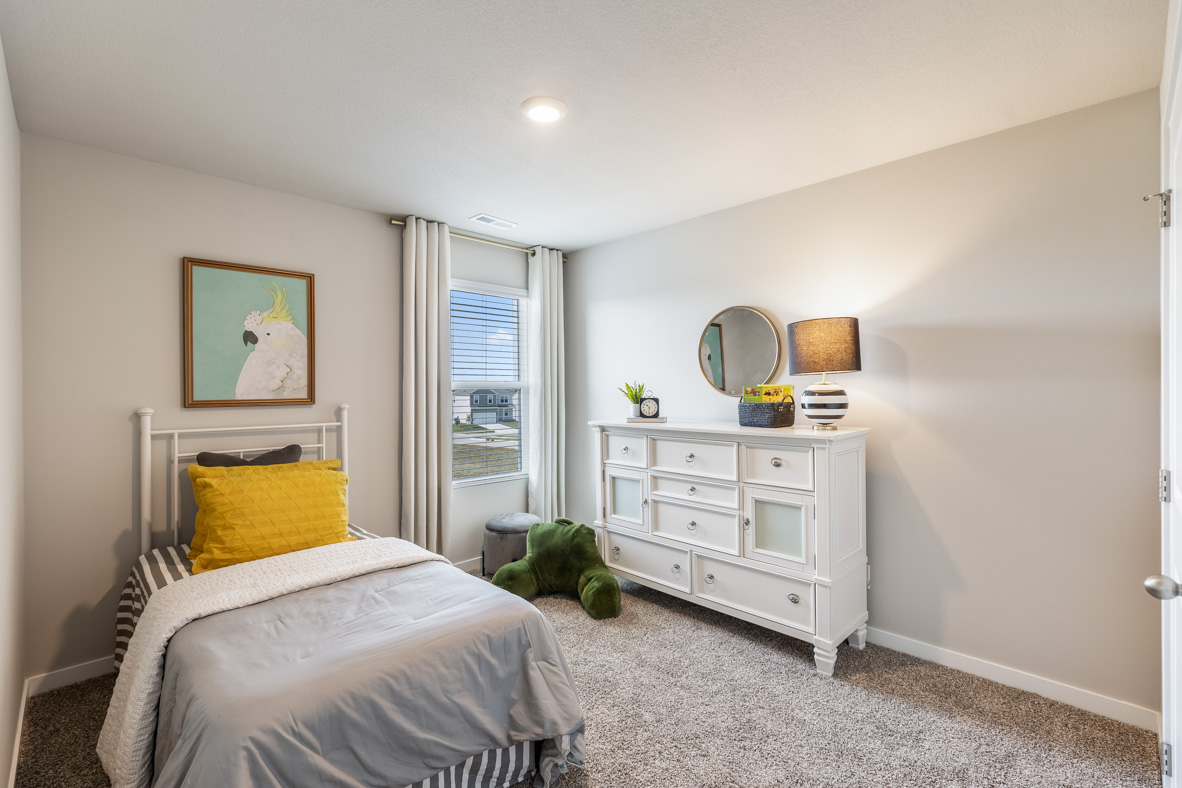 third bedroom with a twin bed and a white dresser
