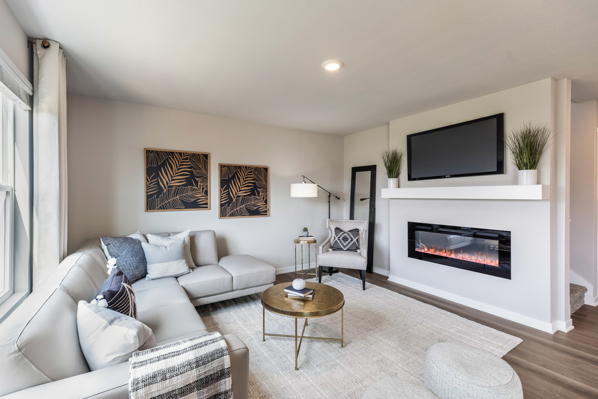 Bellhaven living room showcasing the fireplace with a sectional, coffee table and a chair in the corner