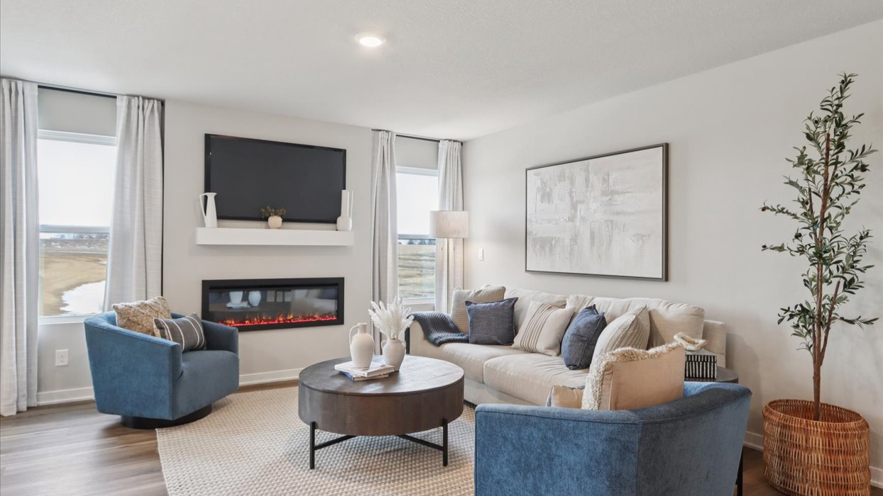 bright hamilton living room with two windows and electric fireplace