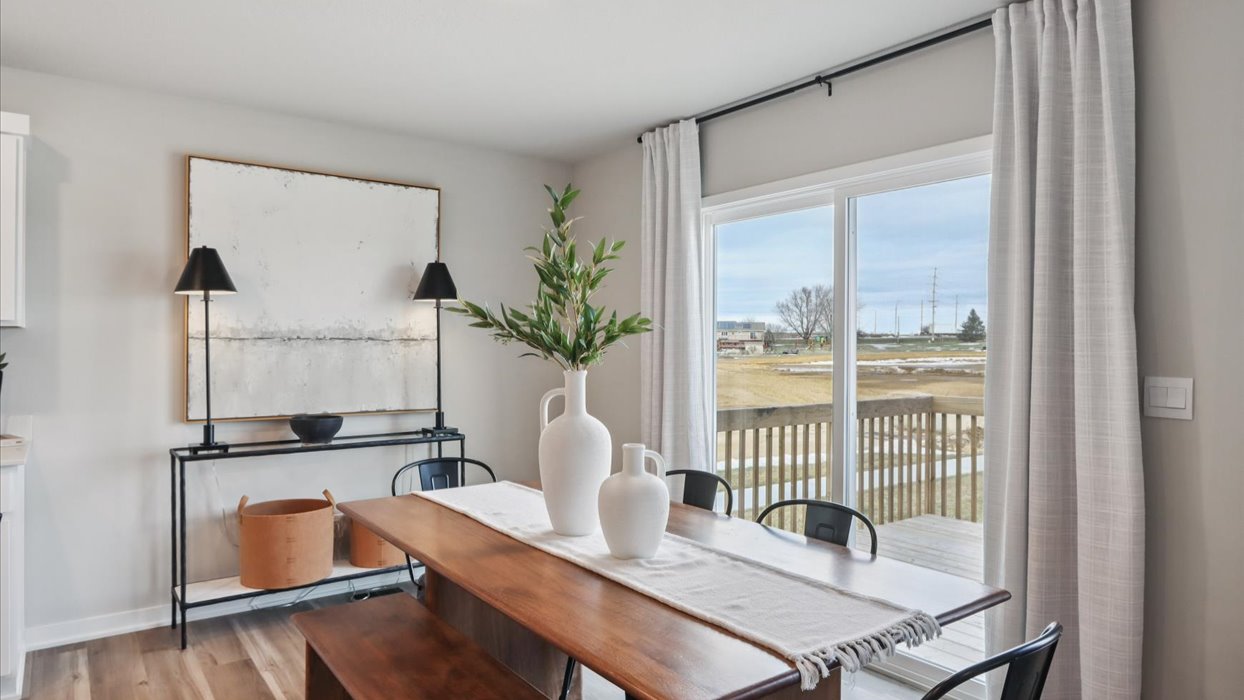 dining area with wood table next to sliding glass doors