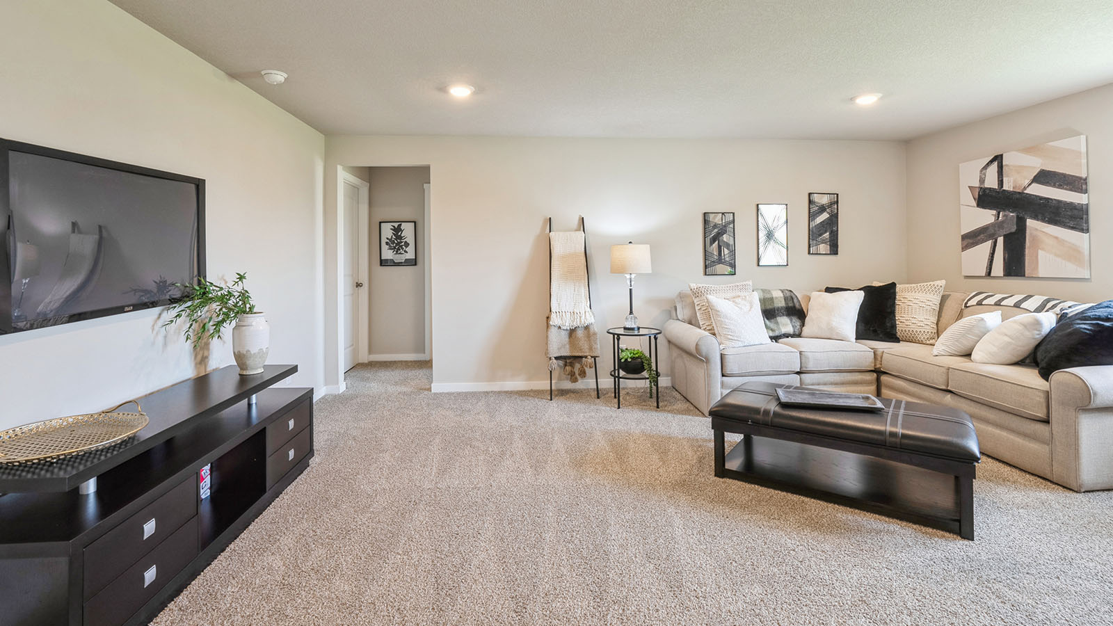 Finished basement with carpeted floors and a window.