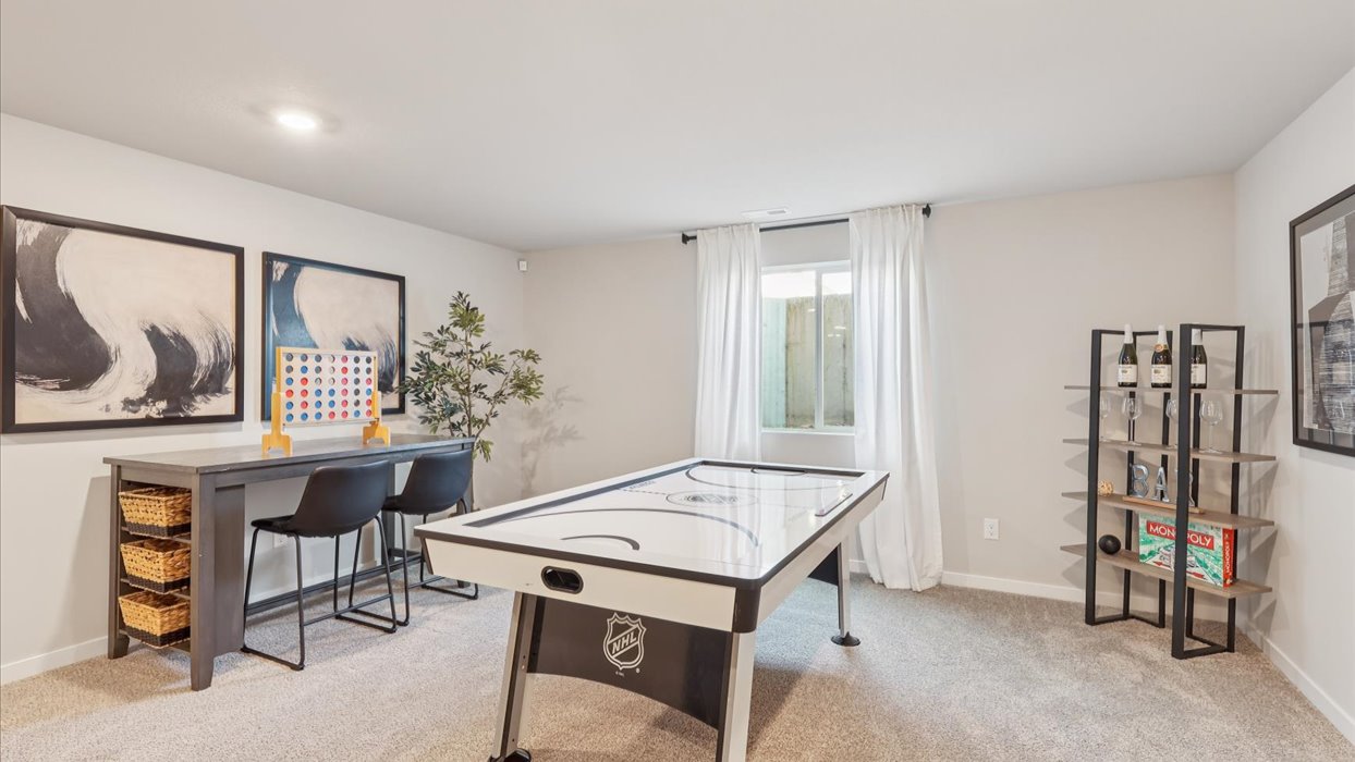 Finished basement living area with comfortable seating space and flexible room for entertaining or relaxing.