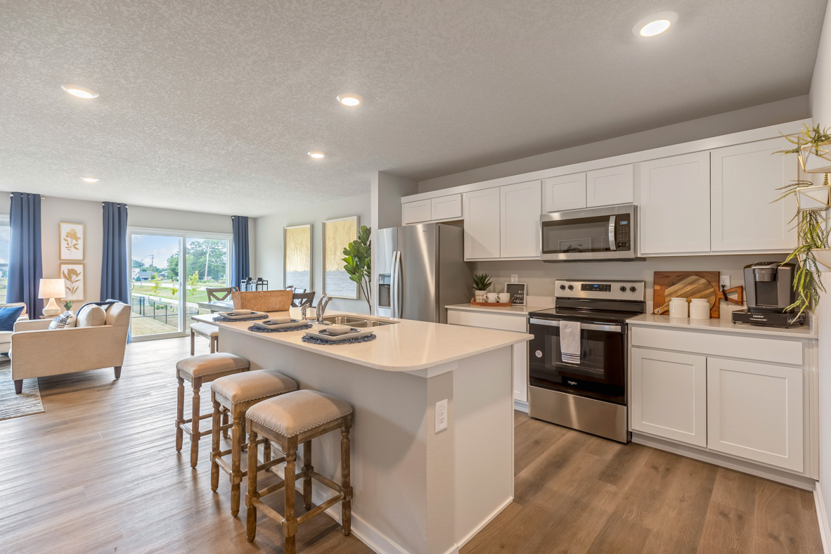 Kitchen with white, shaker-style cabinetry, stainless-steel appliances, and white, quartz countertops in the Roland.mes by D.R. Horton in North Liberty, IA