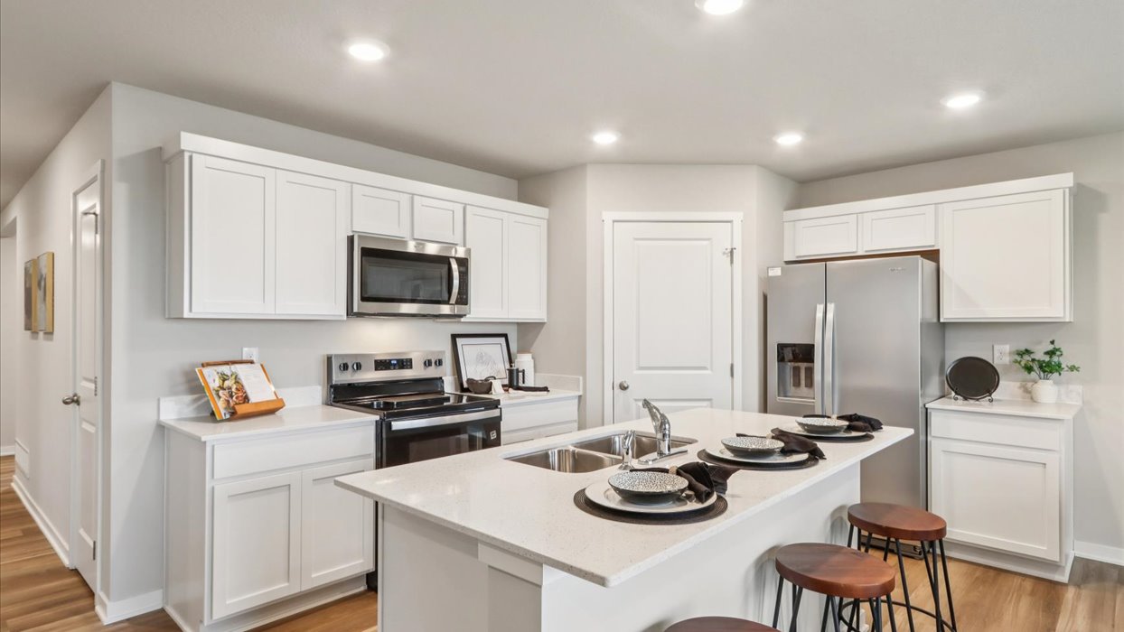 modern kitchen with white cabinets and island