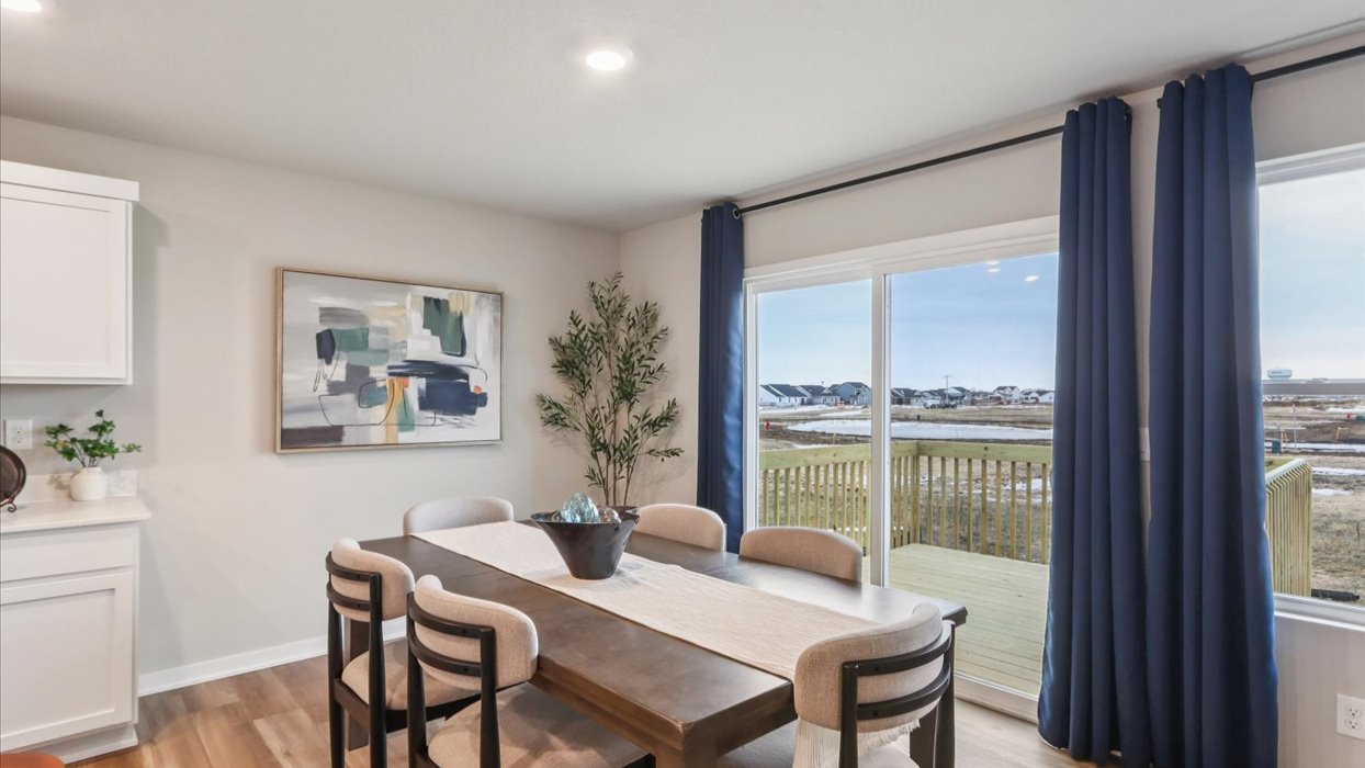 dining area with wood table next to sliding glass doors