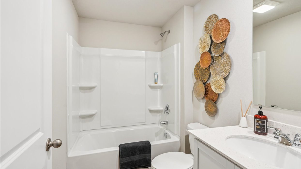 Bathroom with tub and shower combo, quartz countertops, and white vanity