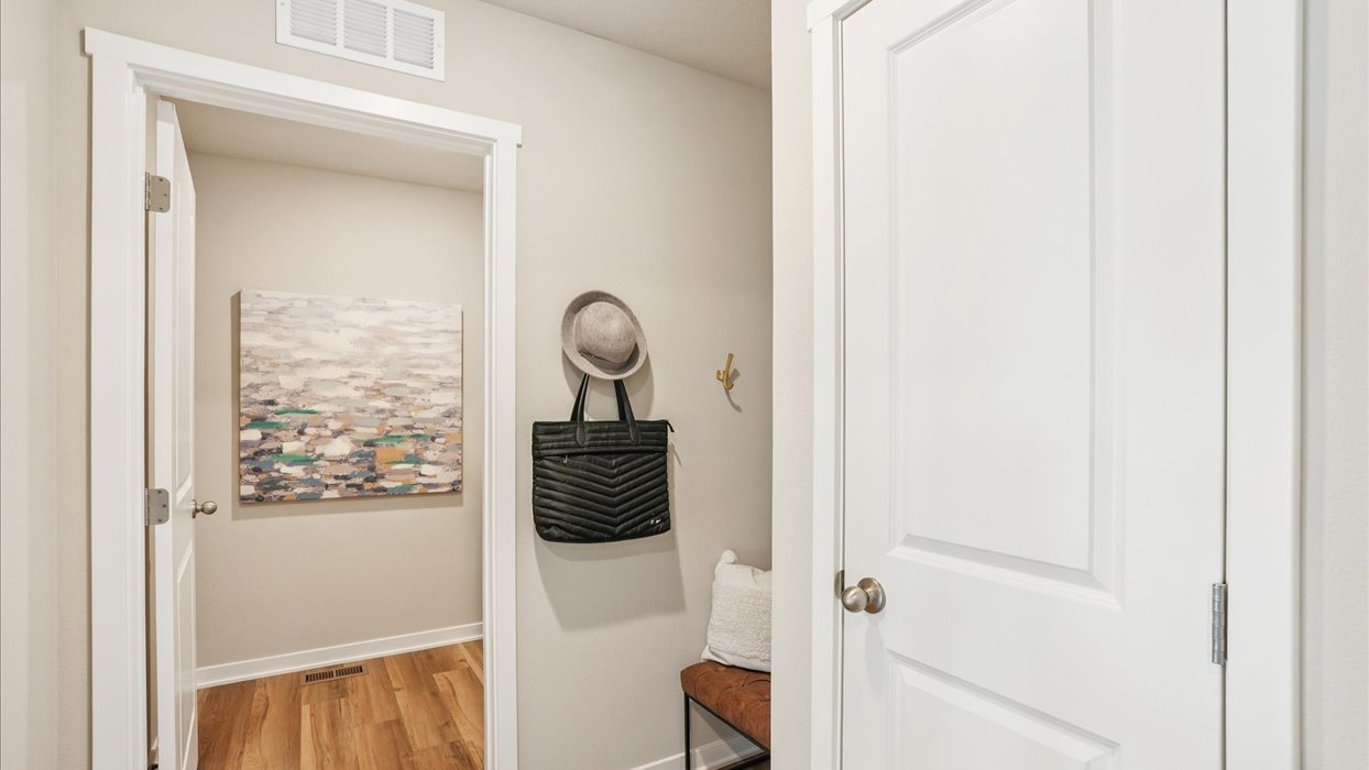 Entry space from the garage featuring a convenient coat closet and room for organization.