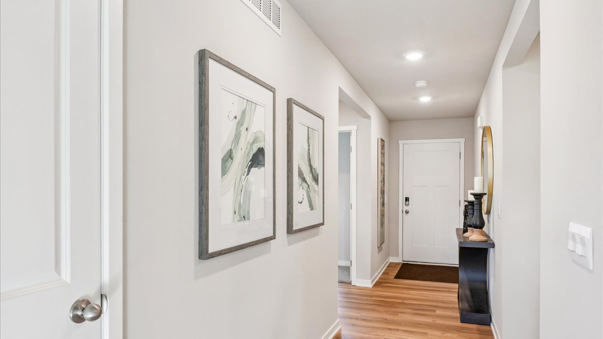 Bright front hallway featuring a welcoming entry space and room for a small table or accents.