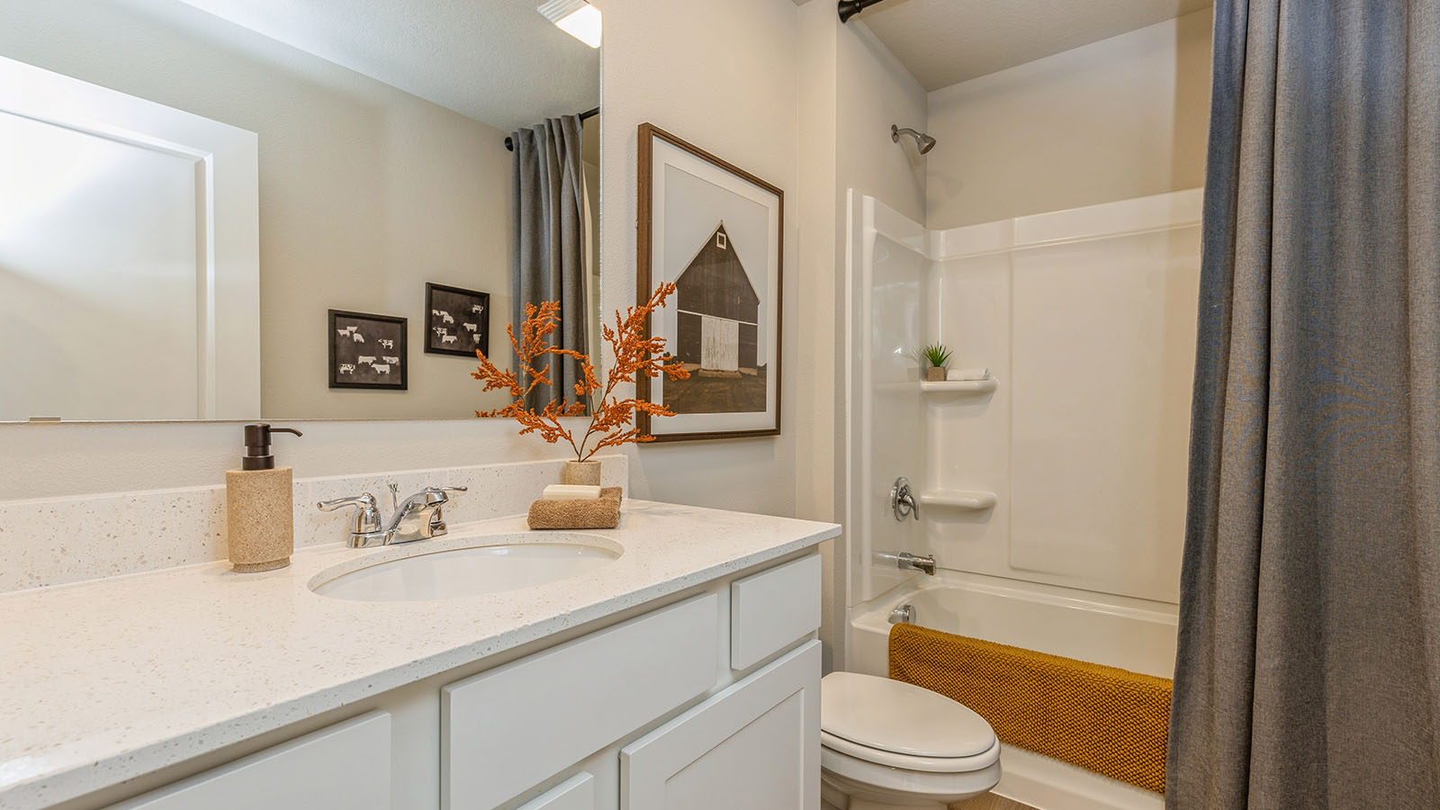 Bathroom with tub and shower combo, quartz countertops, and white vanity