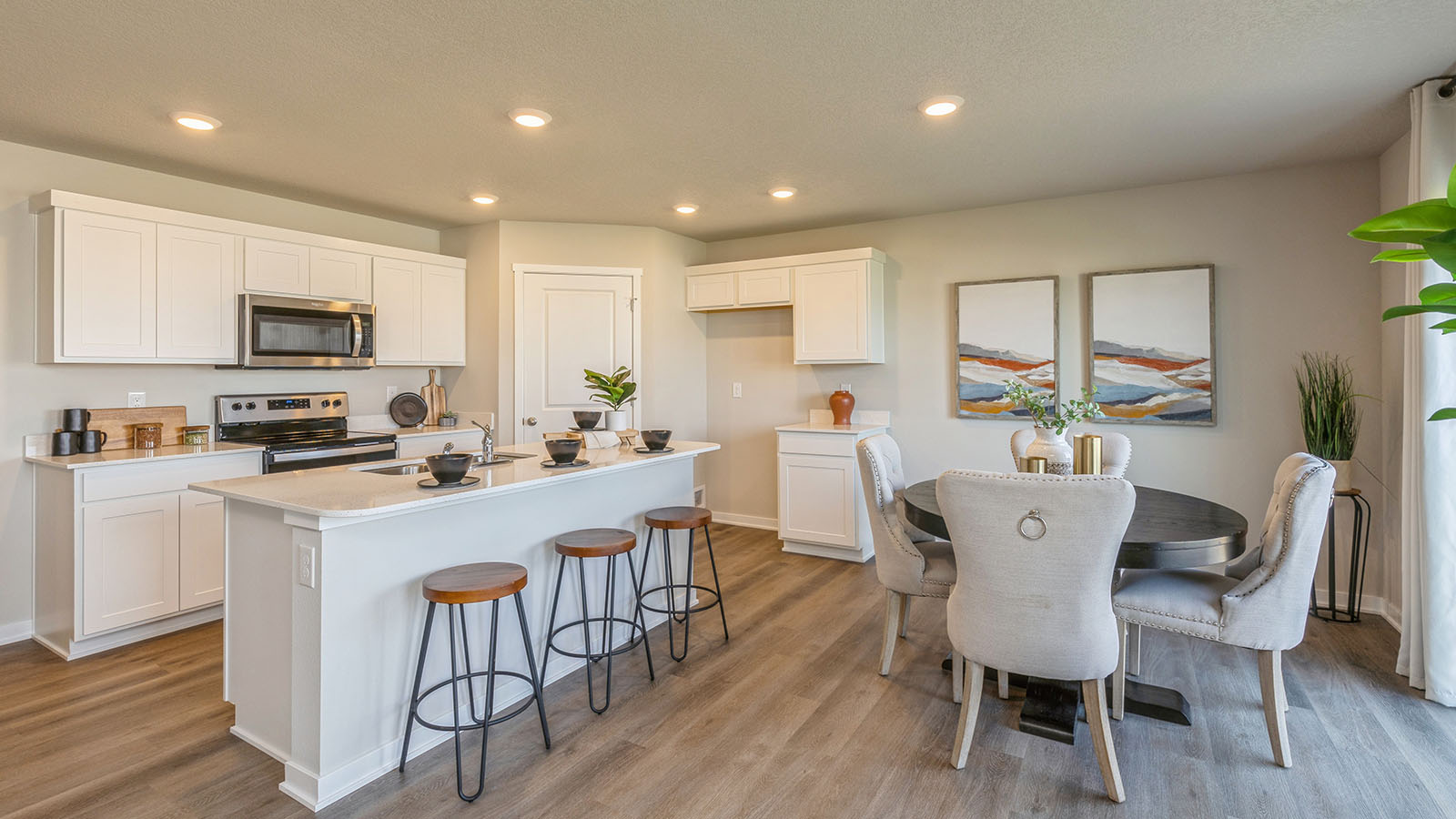 Kitchen with stainless steel appliances, quartz countertops, and white cabinetry