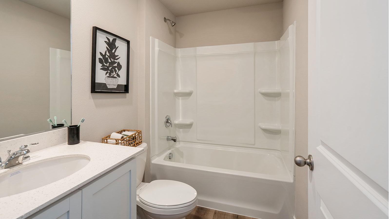 Bathroom with tub and shower combo, quartz countertops, and white vanity