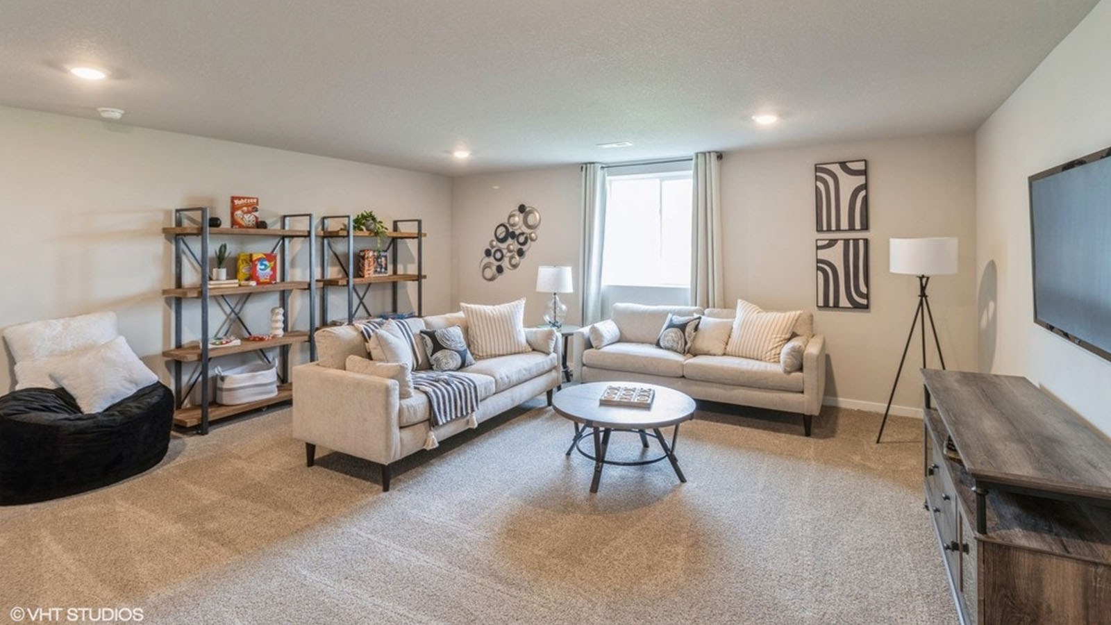 Finished basement living area with comfortable seating space and flexible room for entertaining or relaxing.