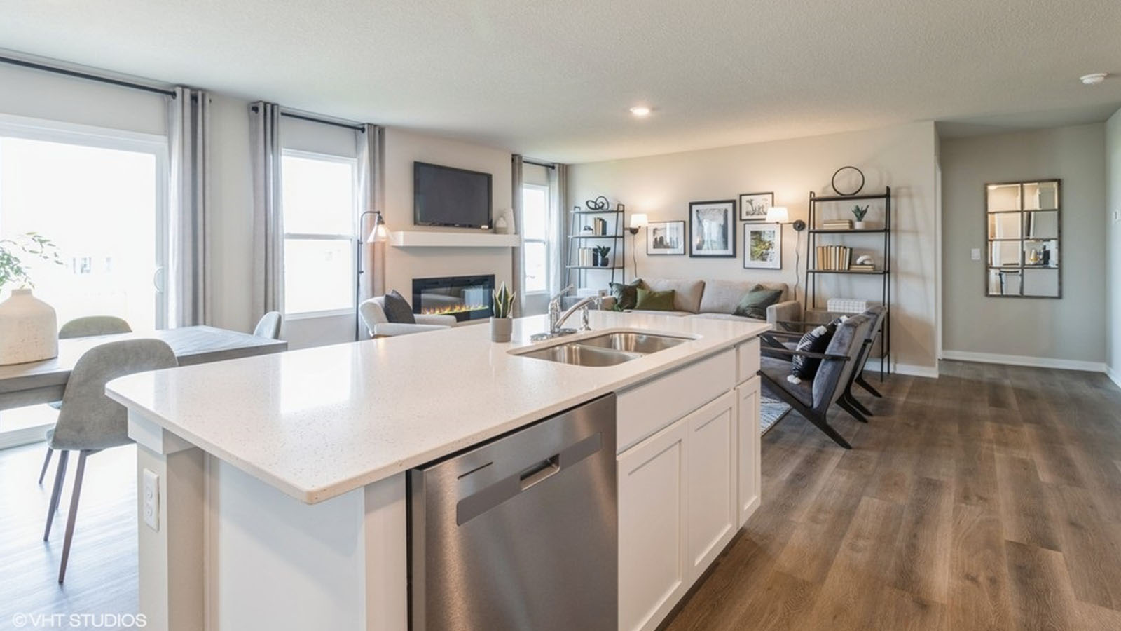 Kitchen with stainless steel appliances, quartz countertops, and white cabinetry
