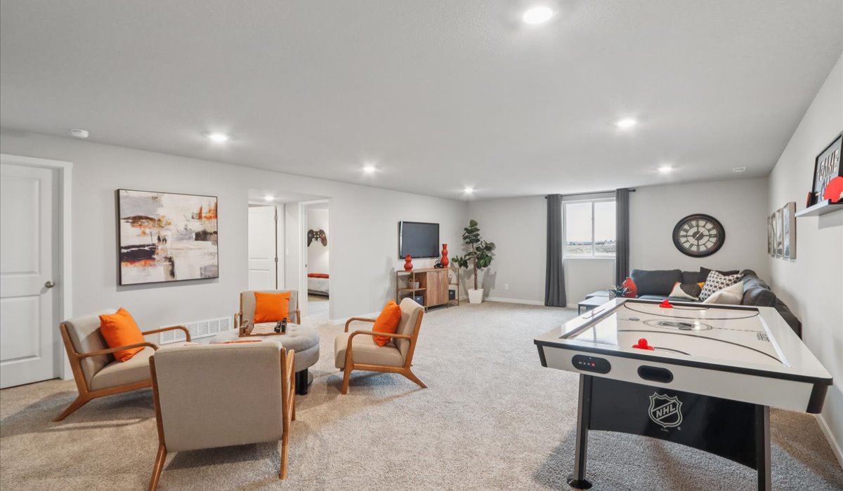 Finished basement living area with comfortable seating space and flexible room for entertaining or relaxing.