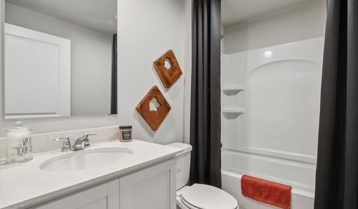 Bathroom with tub and shower combo, quartz countertops, and white vanity