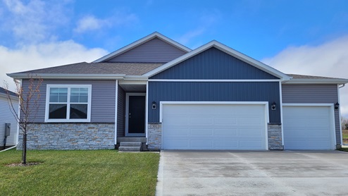 front exterior of neuville home with 3 car attached garage
