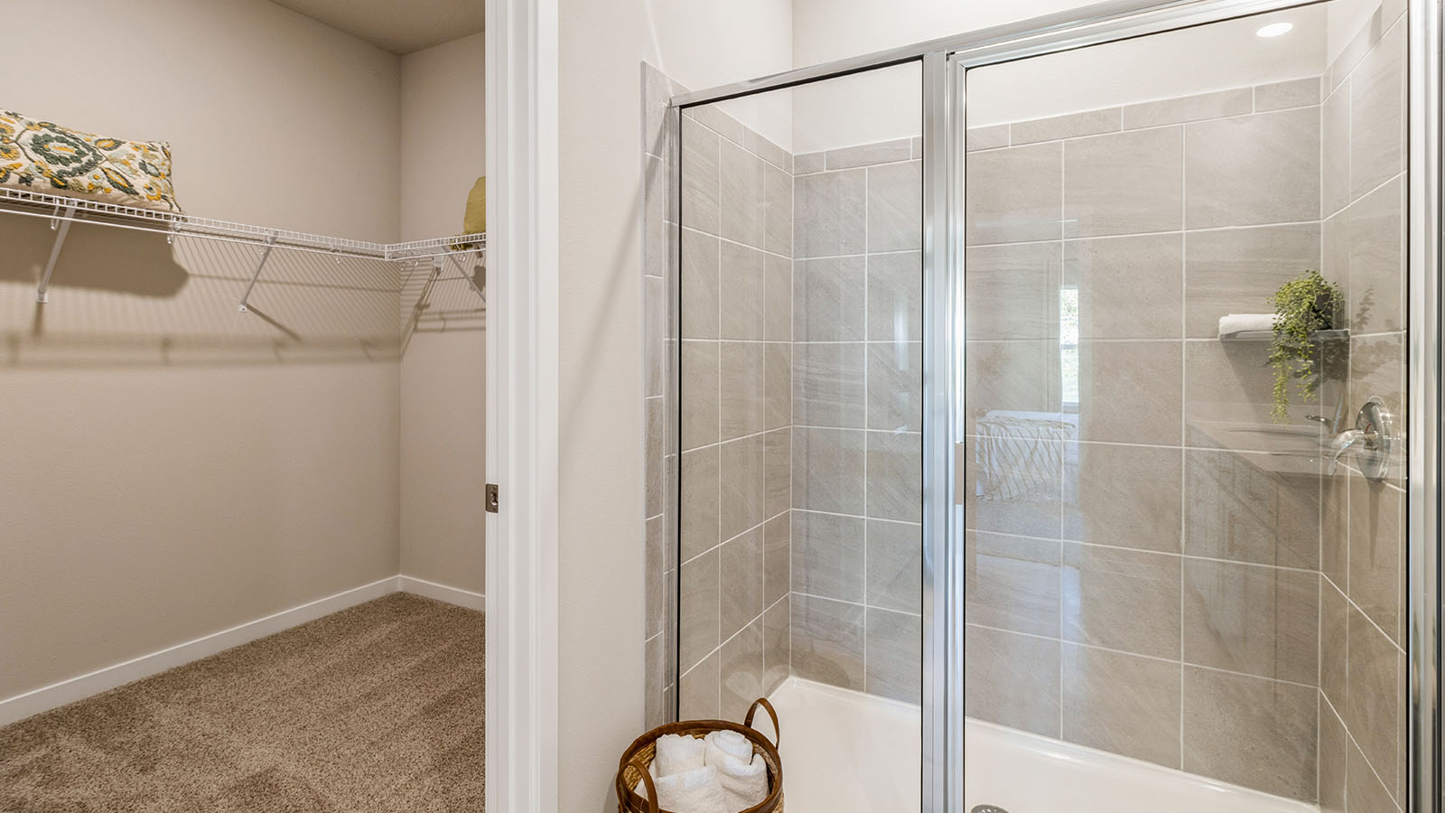 Spacious primary bathroom featuring dual vanities, modern fixtures, and a walk-in shower.