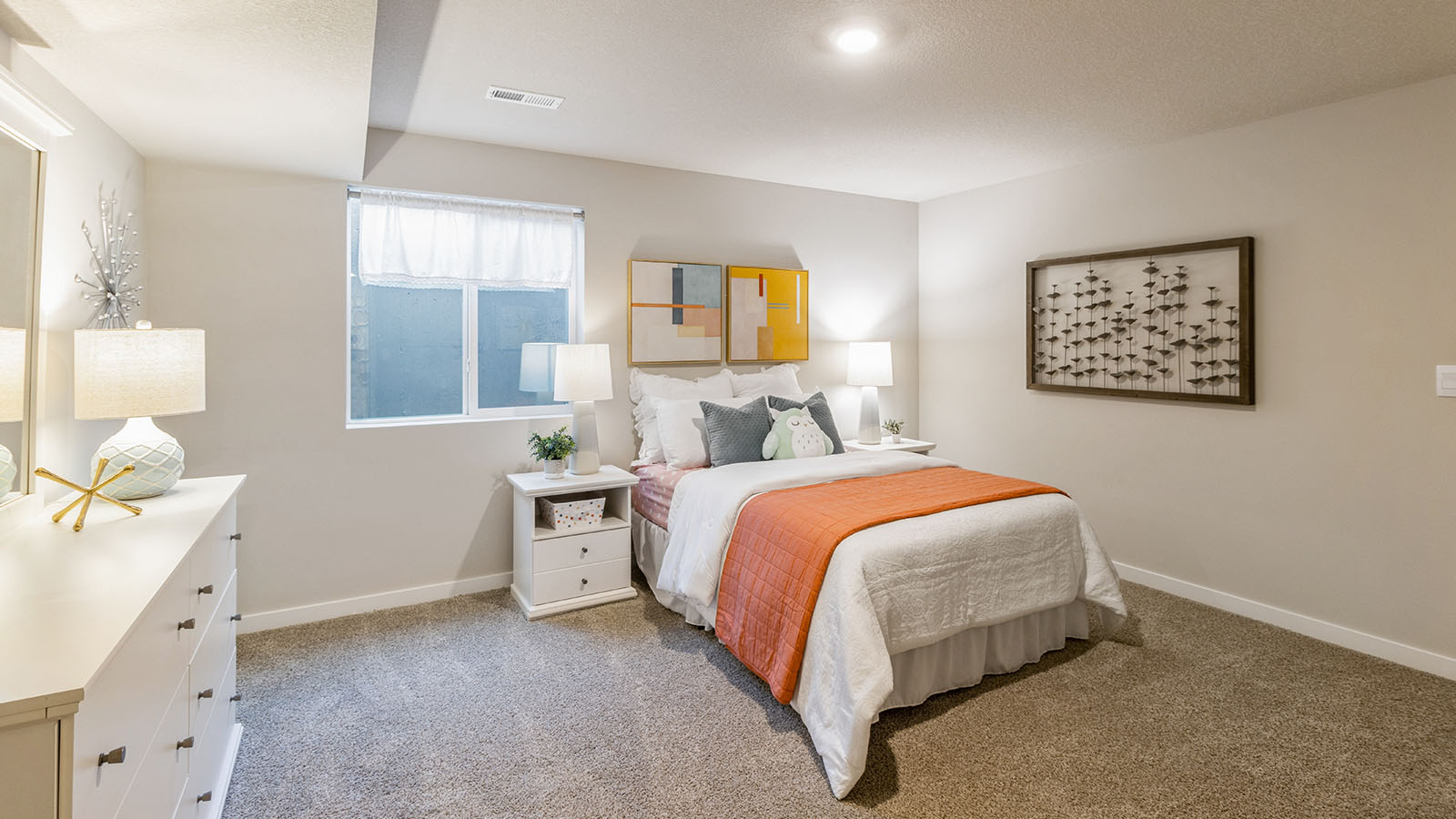 Private lower-level bedroom with natural light and functional storage space.