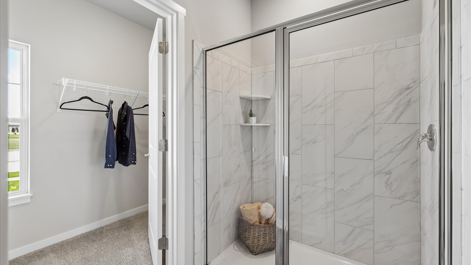 Spacious primary bathroom featuring dual vanities, modern fixtures, and a walk-in shower.
