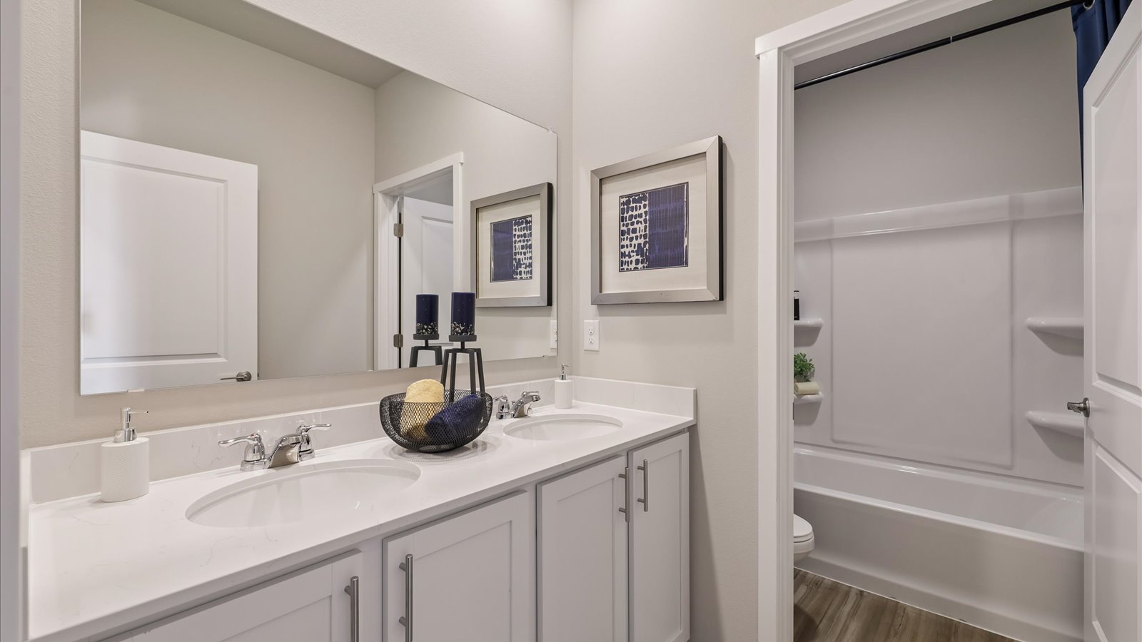 Stylish full bathroom with bright lighting and functional design.