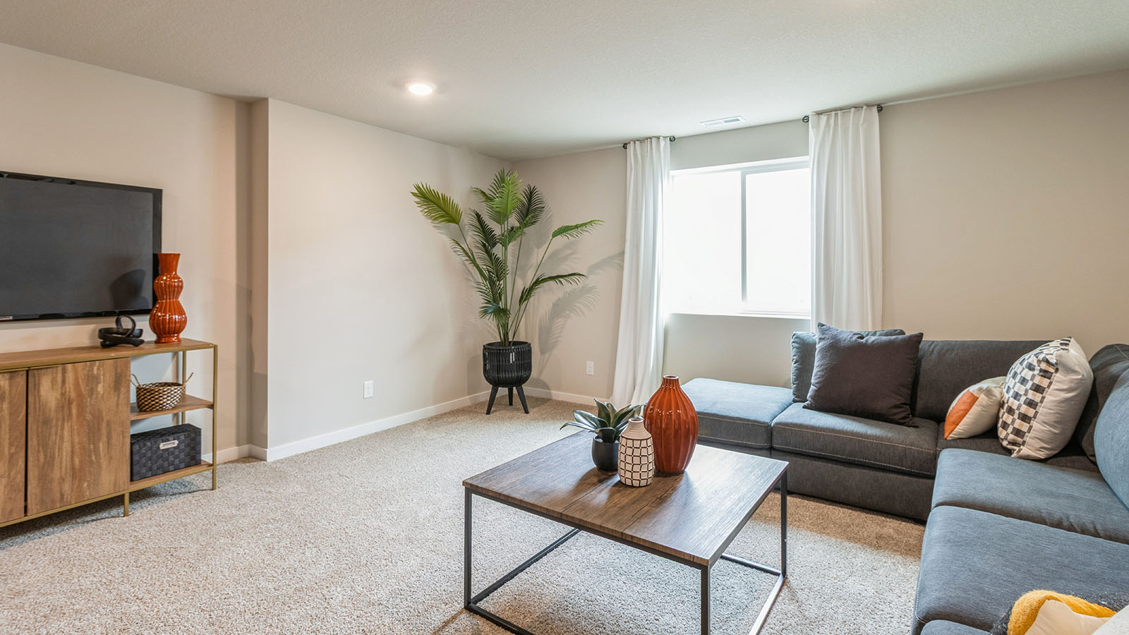 Finished basement living area with comfortable seating space and flexible room for entertaining or relaxing.